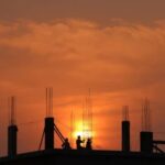 Men in Construction Site During Sunset